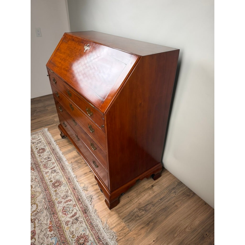 A Chippendale Cherry Slant-Front Desk with Ogee Bracket Feet, possibly Connecticut River Valley, circa 1770–1790, is an 18th-century cherry wood desk with a slant front, four drawers, and brass hardware.