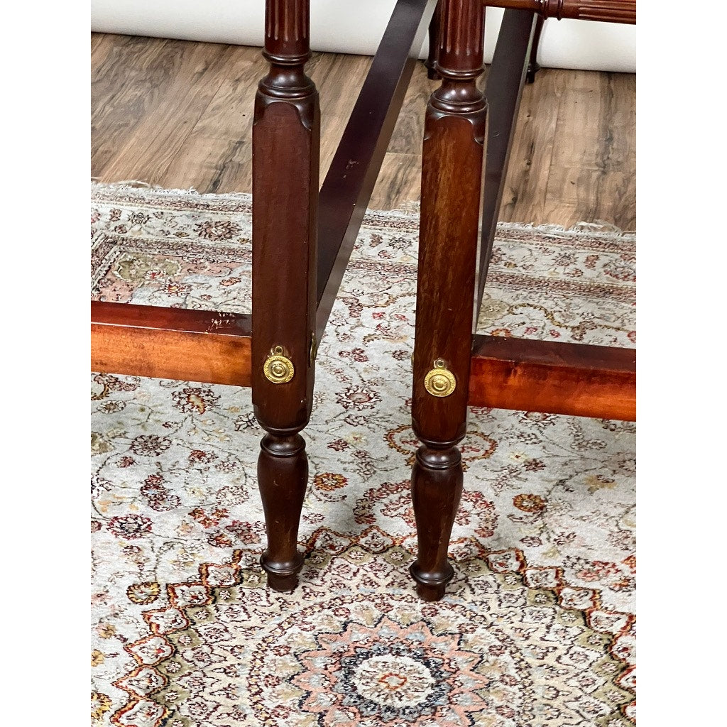 A Vintage Pair Centennial Solid Mahogany Twin Four Poster Beds (c. 1940) with dark wooden legs and brass accents stands atop an ornate area rug featuring cream, brown, and muted red patterns on a wooden floor.