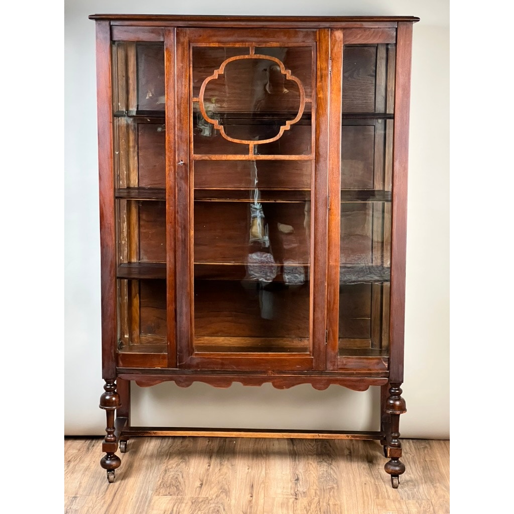 Depression Era Mahogany Curio Display Cabinet with Glass Sides, Circa 1930s. This vintage American furniture piece features ornate legs, a cloud-shaped cutout on the top center door, glass doors and sides, and visible interior shelves. Brand: None/Unknown.