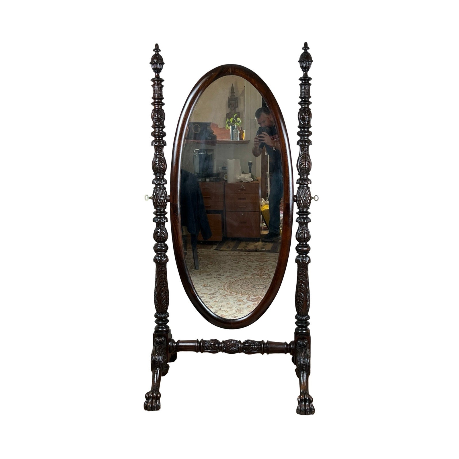 An Impressive Antique American Empire Acanthus and Barbola Rose Carved Cheval Mirror c. 1840 reflects a person taking a photo in a furnished room with a patterned rug.