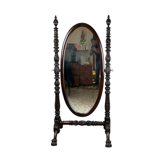 An Impressive Antique American Empire Acanthus and Barbola Rose Carved Cheval Mirror c. 1840 reflects a person taking a photo in a furnished room with a patterned rug.