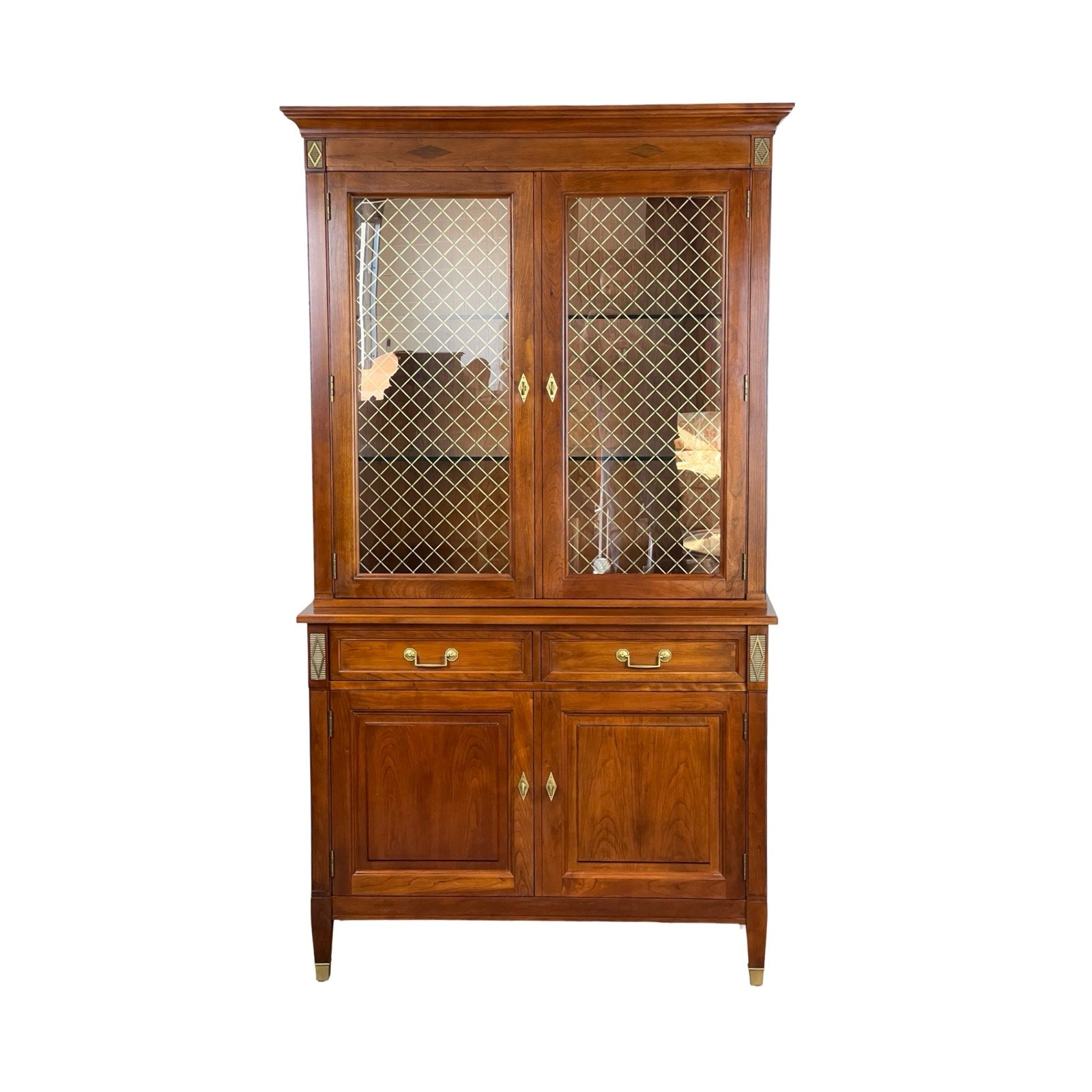 The Vintage William IV Style Cherry Glass Door Bookcase by Stickley features two glass-front upper doors with a diamond lattice pattern, two central drawers, and two lower solid doors accented with brass hardware.