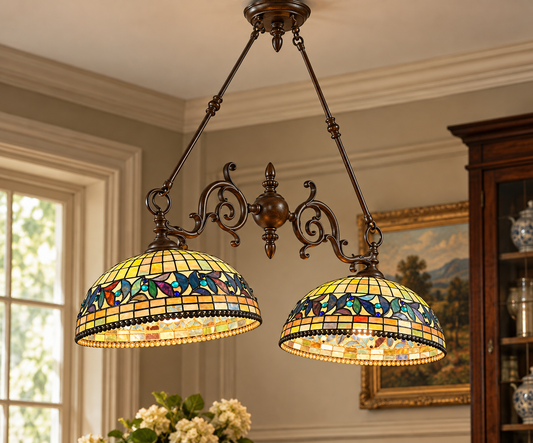 A Vintage Tiffany Style Leaded Stained Glass Double Pendant Billiard Island Light featuring two dome-shaped, multicolored stained glass shades set in a dark metal frame.