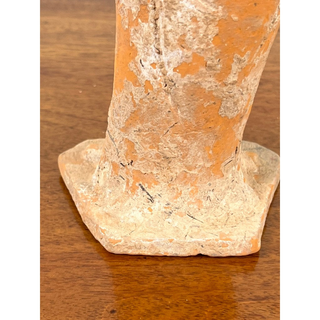 Close-up of the base of an Antique Chinese Tang Dynasty (618-907 AD) terracotta figure of a standing court lady with chipped orange and beige paint, showing age, resting on wood. Comes with COA; brand unknown.