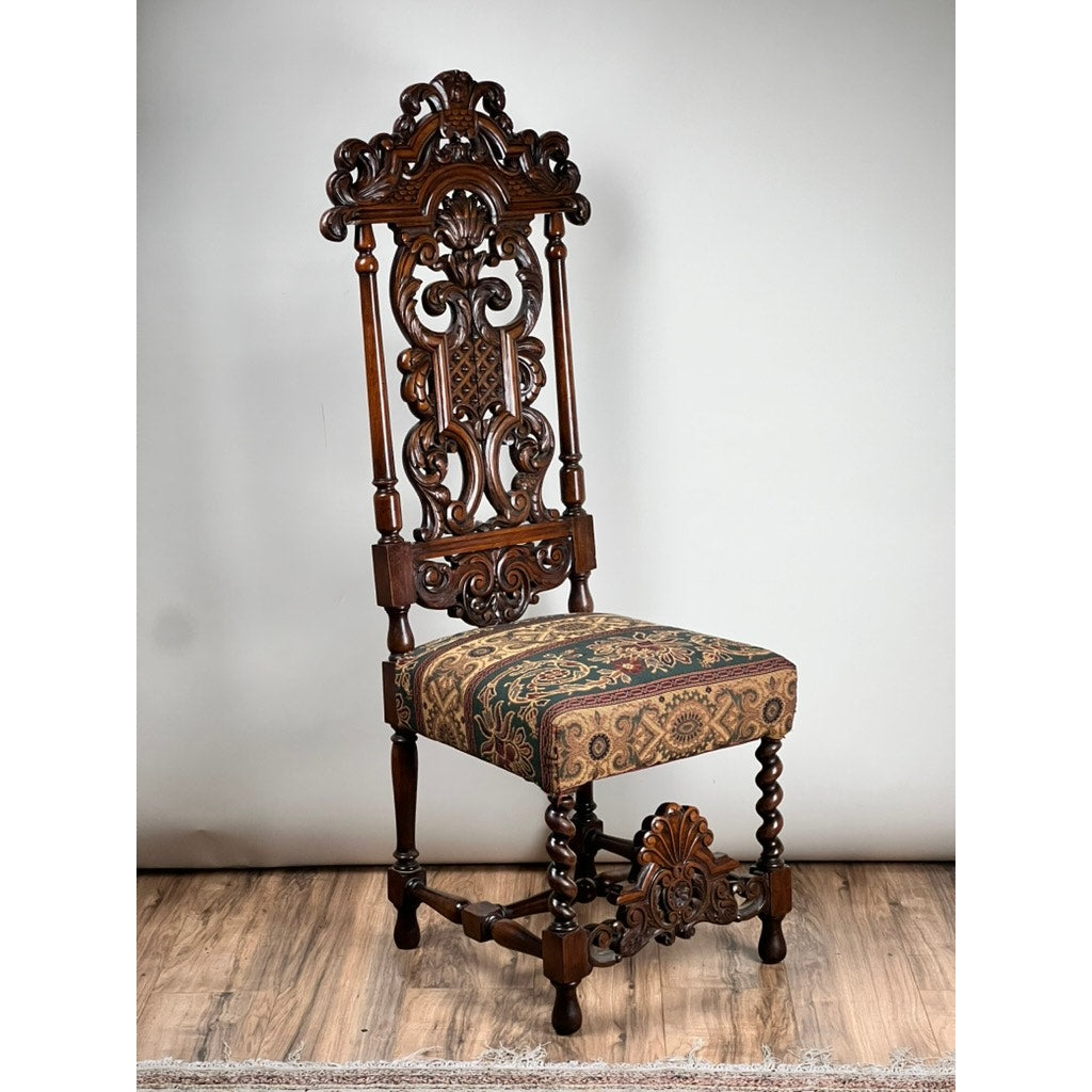 Antique Carolean Revival Side Chair, late 19th century, with intricately carved backrest and legs plus a patterned upholstered seat, shown on a wooden floor against a neutral background. Brand: Unknown.
