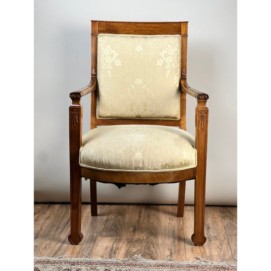 The Pearl City Antiques Antique French Directoire Style Fauteuil Open Arm Chair, crafted from Sapelle mahogany c. late 19th century, features cream floral upholstery on the seat and backrest, and is displayed on a wooden floor with a light background.