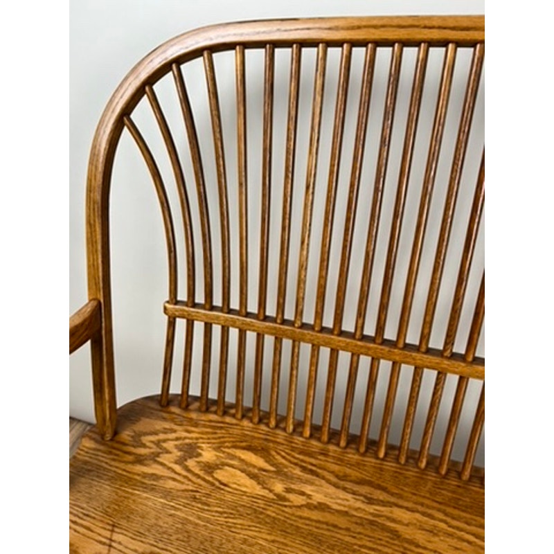 Side view of vintage oak Windsor bench with wide seat