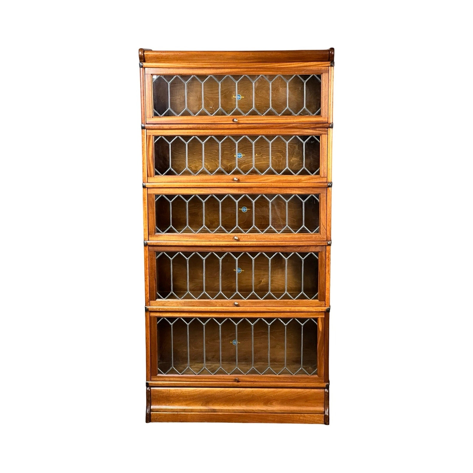 The Globe Wernicke Vintage Globe Wernicke Leaded Glass Five Stack Barrister Bookcase features five stacked sections with geometric leaded glass doors, displayed against a white background.