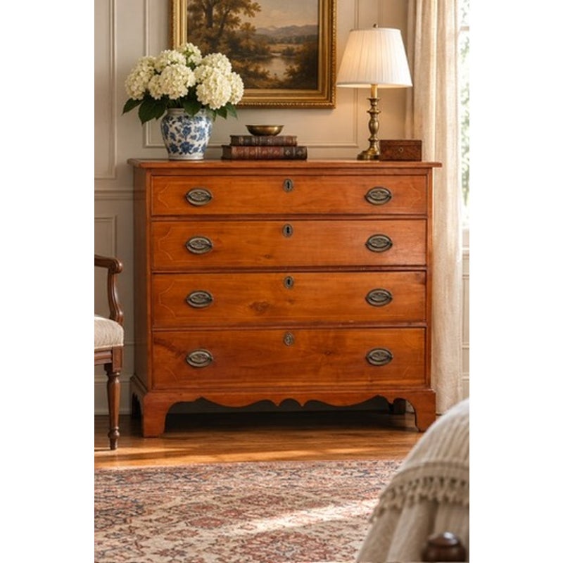 Pennsylvania Federal Cherry Four-Drawer Chest with Satinwood String Inlay, circa 1800–1820, an antique cherry wood chest featuring four drawers with brass oval pulls and keyhole escutcheons.