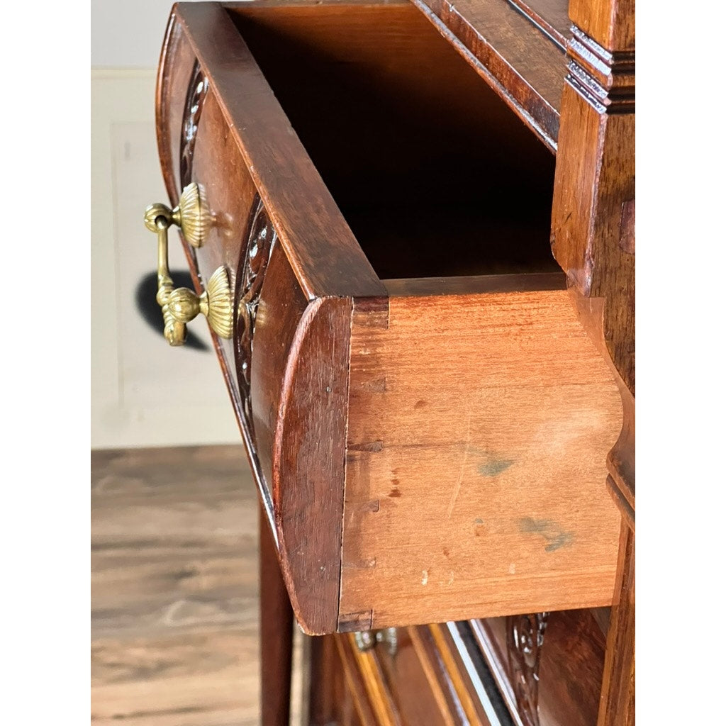 A close-up of an open drawer with ornate brass handles and dovetail joinery, showing scratches, from an Antique Victorian Aesthetic Movement Mahogany Four Over Four Gentlemen’s Chest c. 1880.