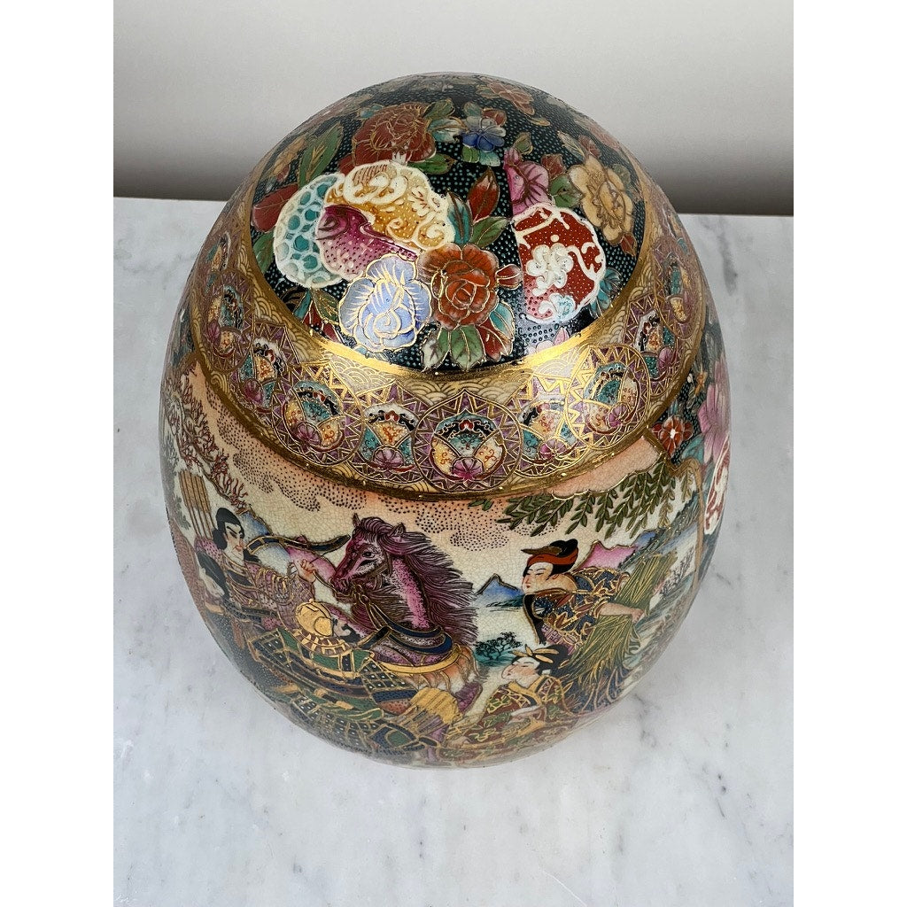 The Large Antique Satsuma Porcelain Egg Chinese Export features intricate, colorful floral patterns and traditional figures, displayed against a white marble surface. Brand is unknown.