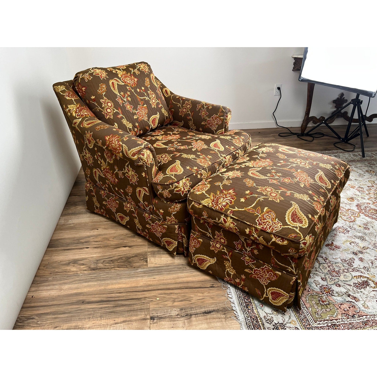 Side view of vintage upholstered club chair and matching ottoman