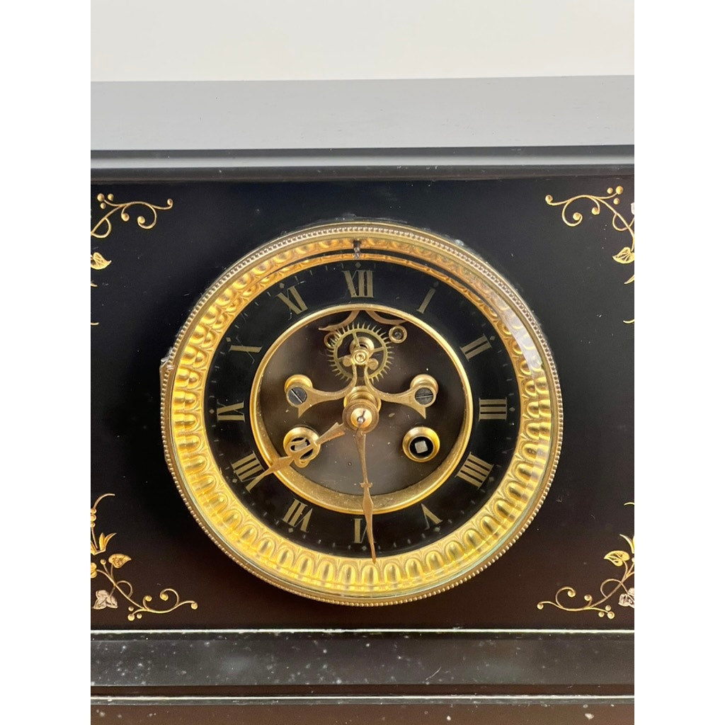 A close-up of an Antique Victorian Slate Mantle Clock with Open Escapement, 8 Day Time and Strike, c. Late 19th Century, featuring a gold rim, Roman numerals, ornate gold patterns on black slate; clock hands at about 10:16.