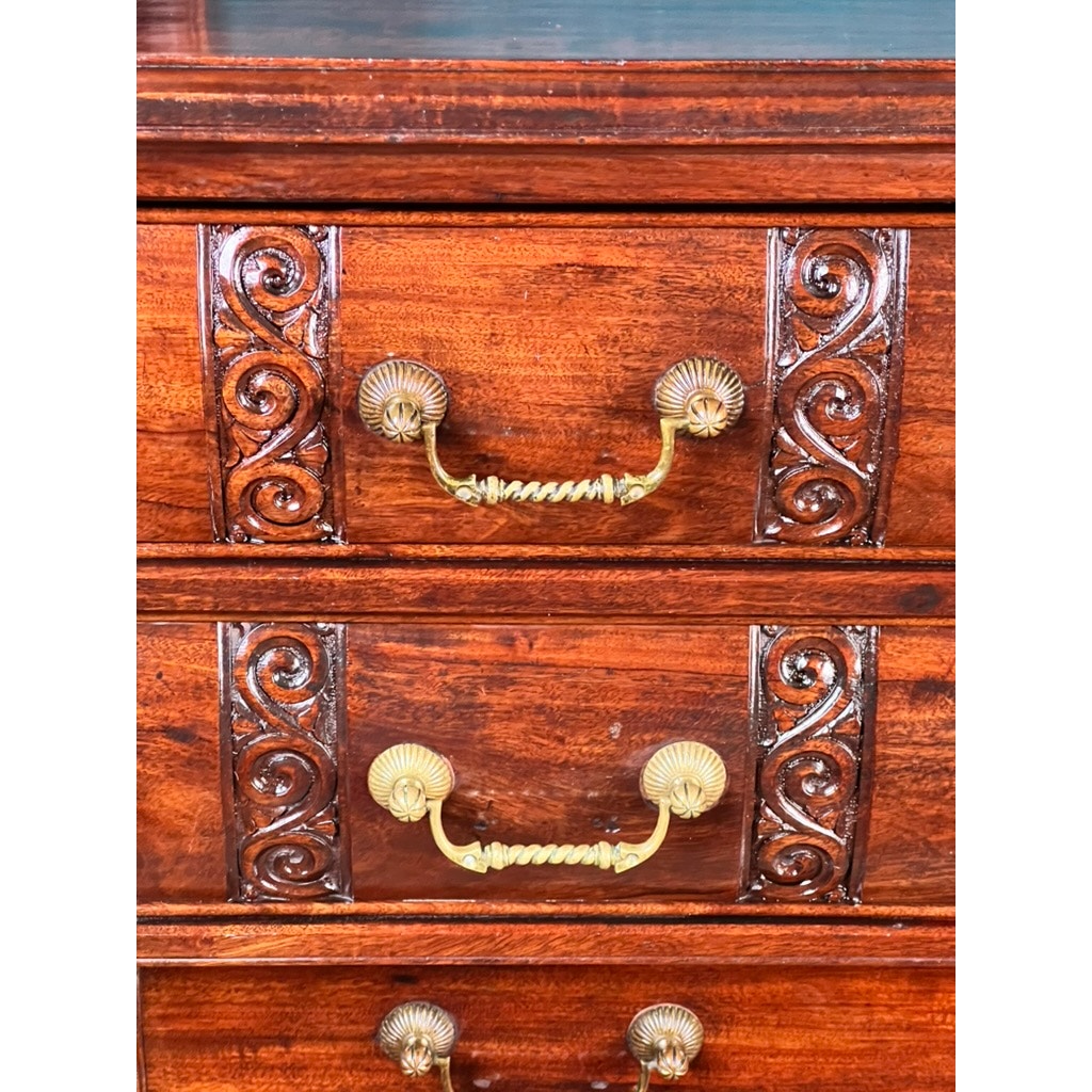 Close-up of two wooden drawers from an Antique Victorian Aesthetic Movement Mahogany Four Over Four Gentlemen’s Chest c. 1880, showing ornate brass handles, carved patterns, and a polished rich brown finish. Brand: Unknown.