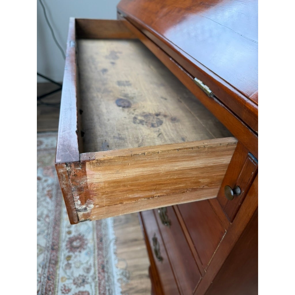 A Chippendale Cherry Slant-Front Desk with Ogee Bracket Feet, Possibly Connecticut River Valley, circa 1770–1790, featuring an open drawer that reveals a worn cherry wood interior.