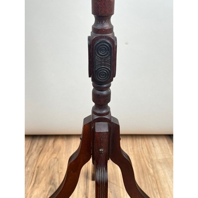 A close-up of an Antique Victorian Marble Top Plant Stand (late 19th century) with ornate carved details and geometric patterns, showcased on a wooden floor against a light background. Brand: Unknown.
