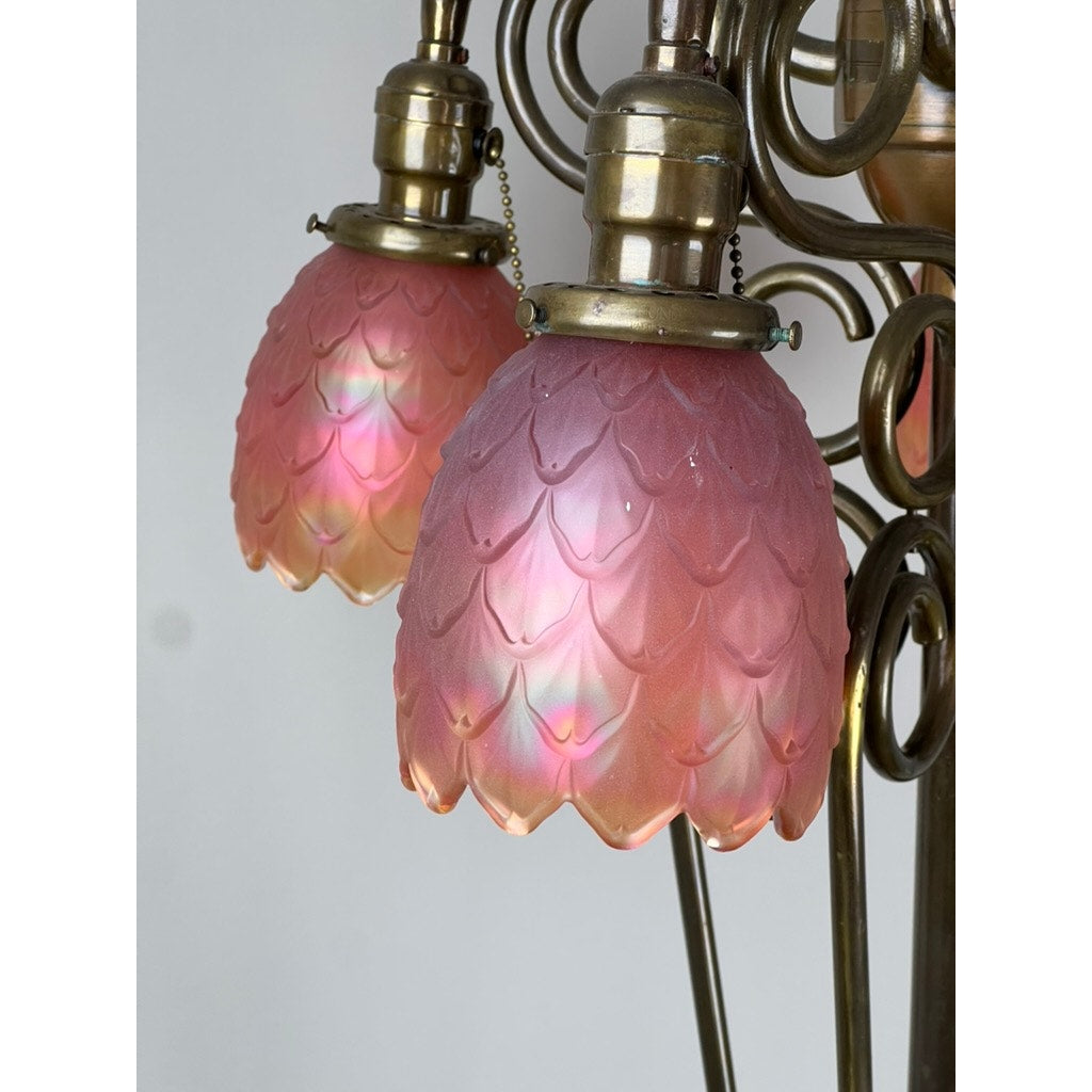 Close-up of an Antique Art Nouveau Brass Floor Lamp (c.1920, attr. Jules Cayette & Charles Schneider) with pink, flower-shaped glass lampshades featuring a textured, petal-like pattern. Brand: None/Unknown.