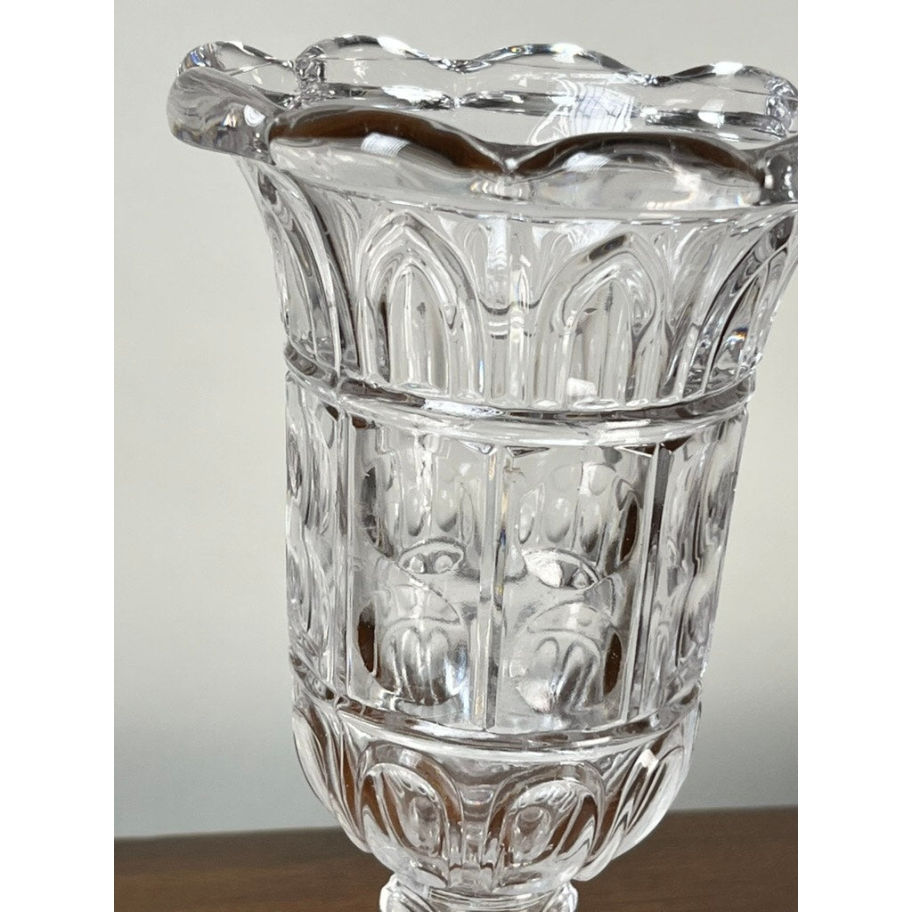 A close-up of an Antique Boston & Sandwich Glass Co. Gothic Arch Pressed Glass Celery Vase (Sandwich Glass, c. 1860–1880) with a scalloped rim, displayed on wood against a plain background.