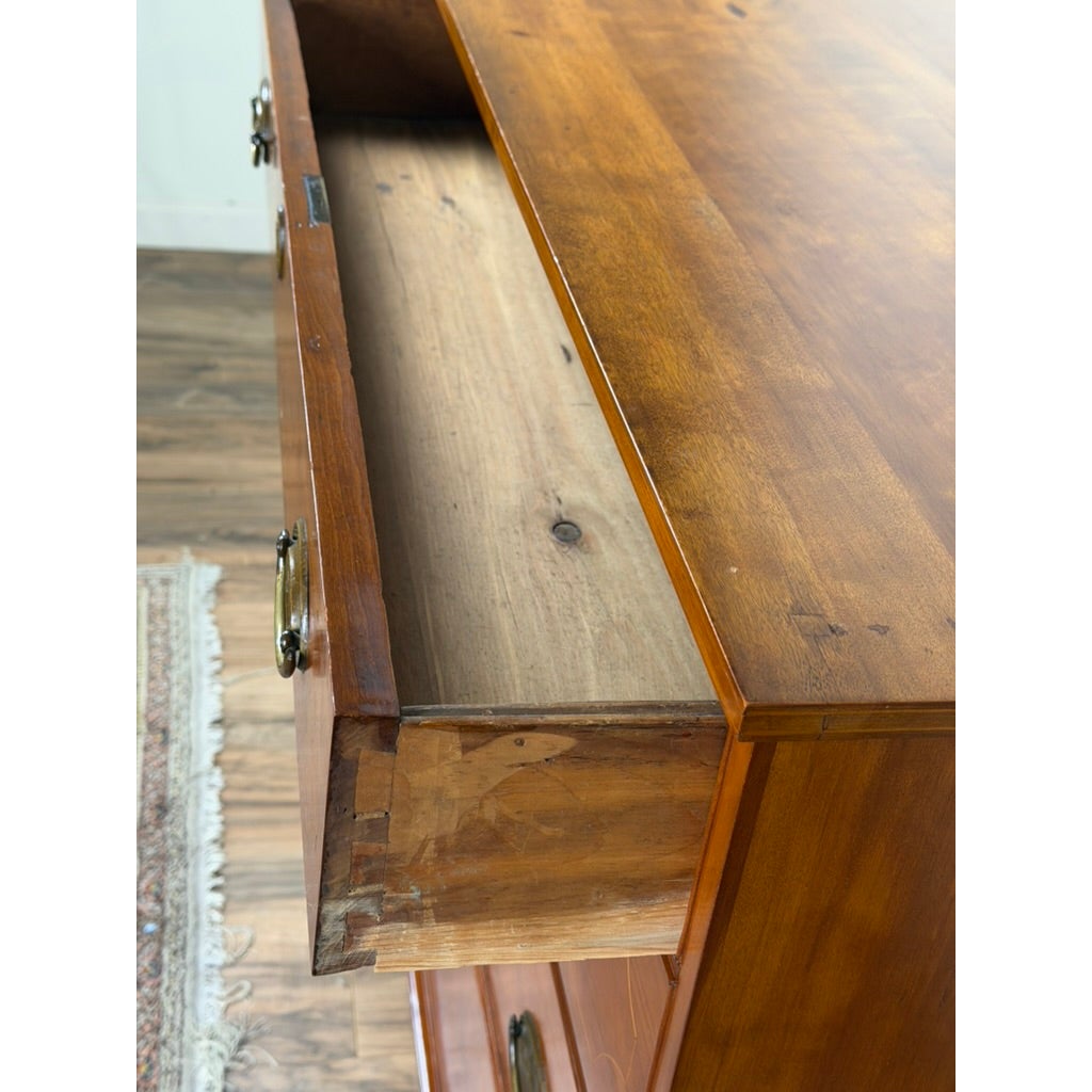 A Pennsylvania Federal Cherry Four-Drawer Chest with Satinwood String Inlay, circa 1800–1820, with the top drawer pulled open to reveal the unfinished cherry interior.