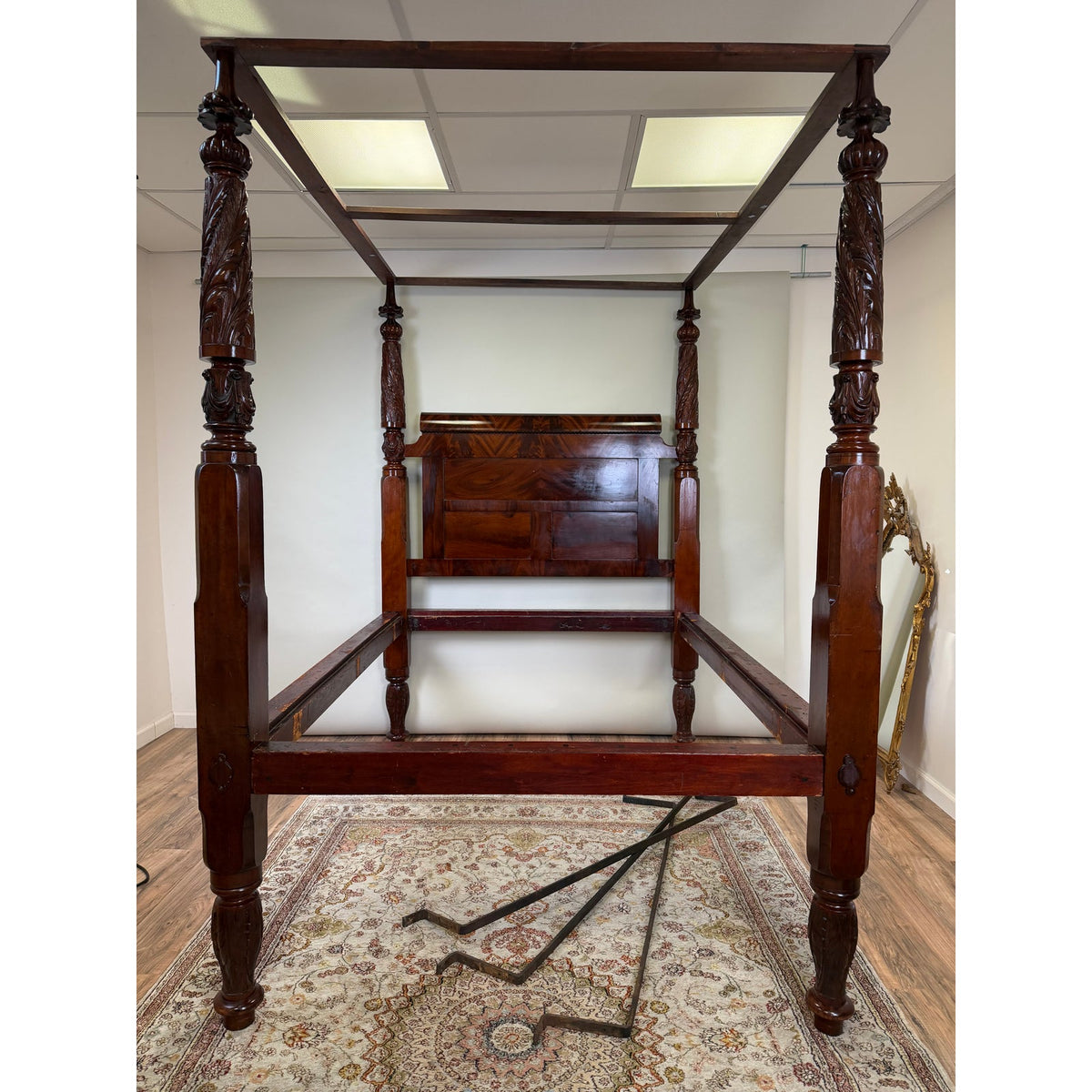 American Classical Carved Mahogany Four-Poster Tester Bed, circa 1825–1840, featuring carved columns and a rectangular headboard.