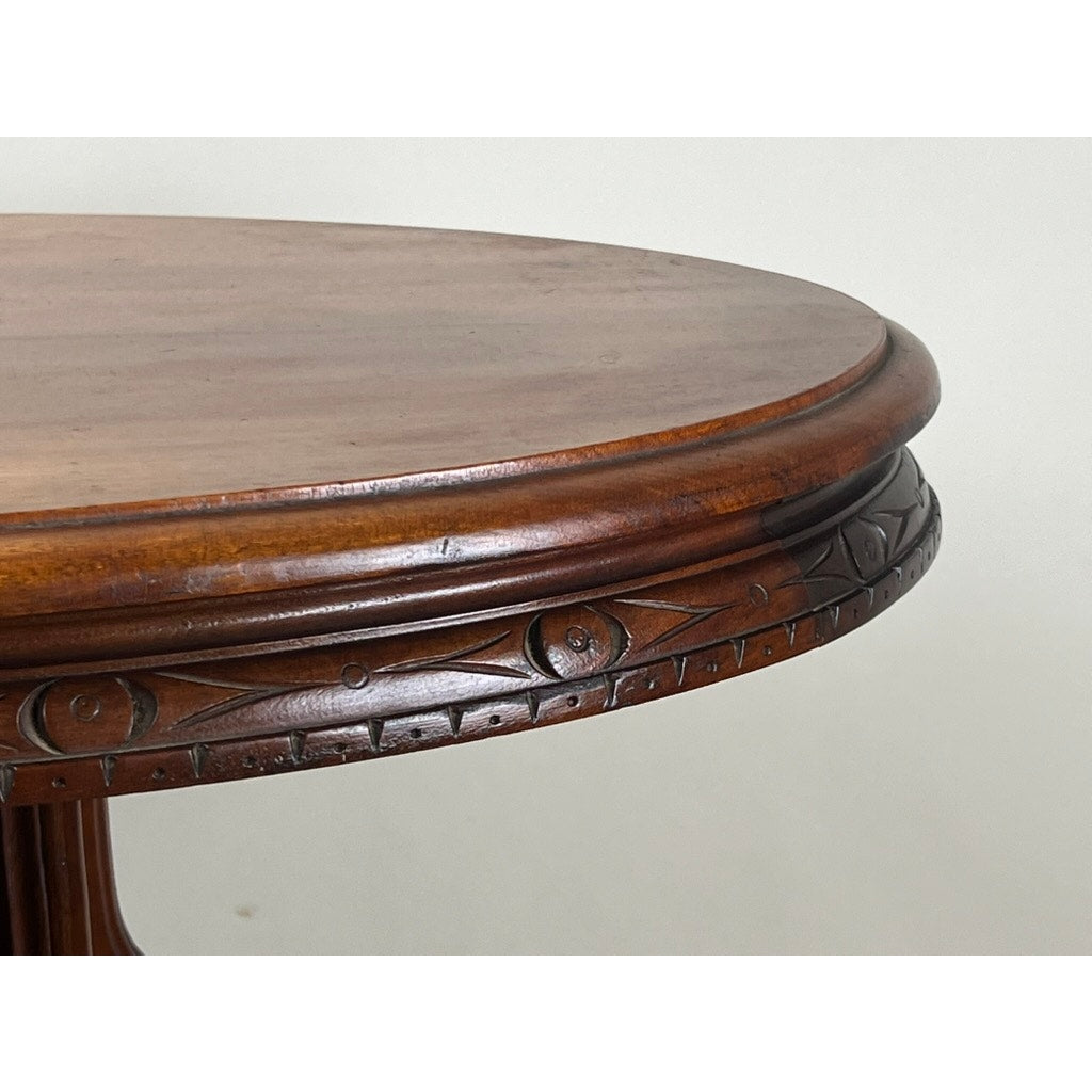Close-up of the edge of an Antique Victorian Walnut Lamp Stand from the late 19th century, featuring carved decorative patterns and a smooth, polished wooden rim. The background is plain and light-colored. Brand: Unknown.