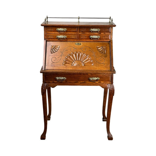 Antique Victorian Oak Ladies Writing Desk c. 1900 with ornate carvings, curved legs, multiple small drawers, and a slanted front panel featuring decorative shell and floral motifs. Brand: Unknown.