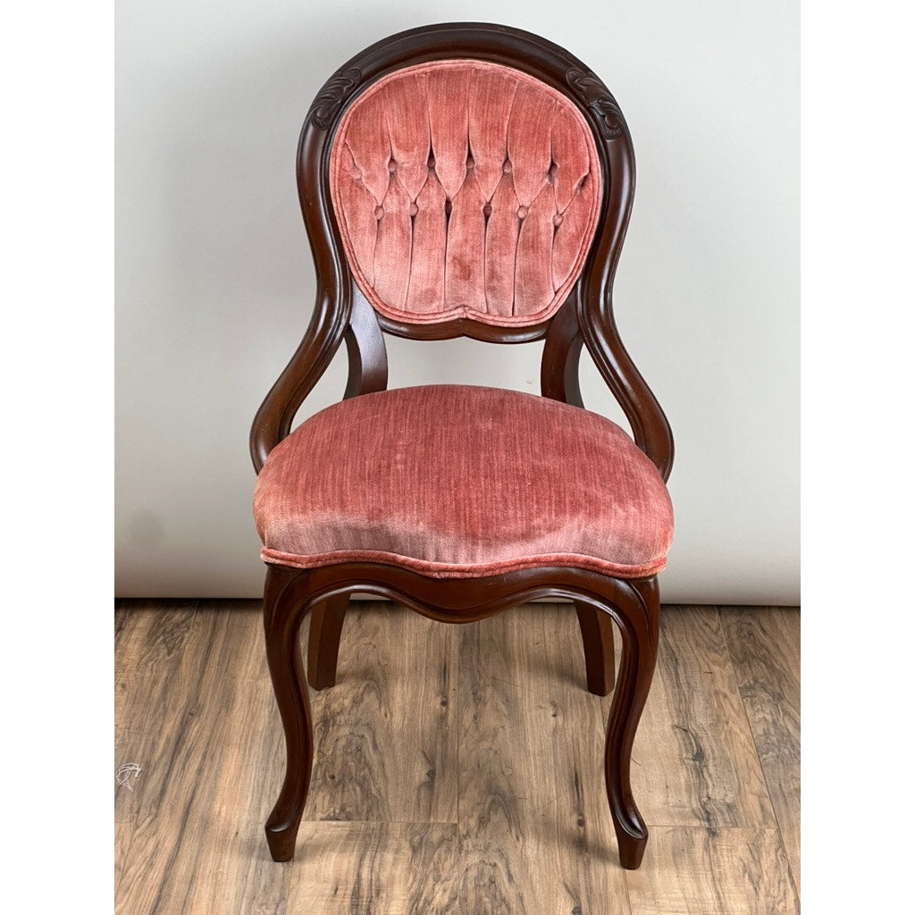 Antique Victorian Walnut Tufted Balloon Back Side Chair (late 19th c.) with curved legs, armrests, and pinkish-red velvet seat and tufted backrest, shown against a plain light wall and wooden floor. Brand: None/Unknown.