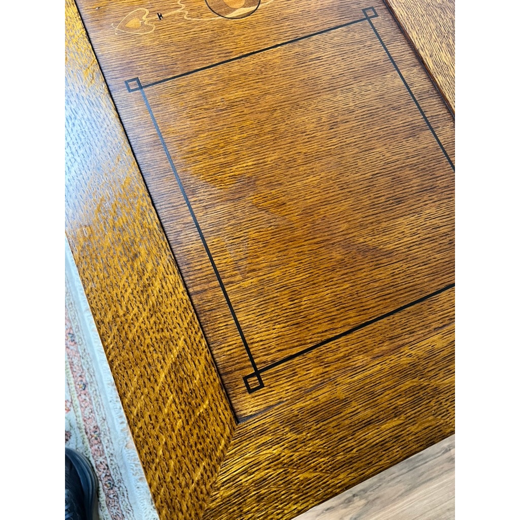 Close-up of the Stickley Vintage Harvey Ellis Millennium Edition Oak Blanket Chest, showcasing a rich brown finish, rectangular inlay with black lines, and decorative corner squares—classic elements of Arts & Crafts design.