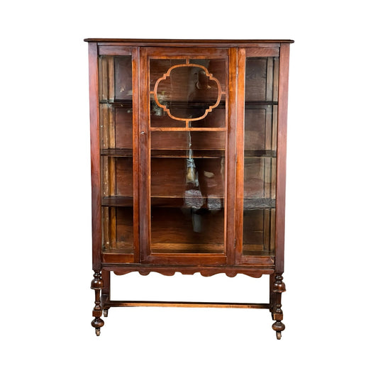 Presenting the Depression Era Mahogany Curio Display Cabinet with Glass Sides, Circa 1930s—an elegant vintage piece featuring glass doors and sides, interior shelving, and ornate detailing on the legs and door frame. This curio cabinet beautifully showcases timeless craftsmanship from the 1930s.