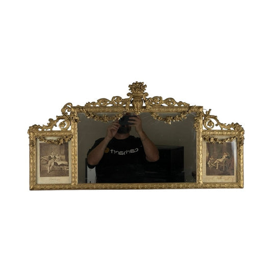 An exceptional antique Louis XV style three panel mirror, flanked by images of Napoleon. A person in a black shirt is visible taking a photo in the mirror’s reflection.