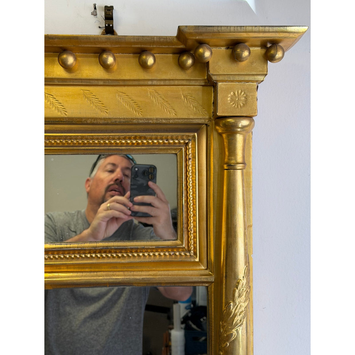 An American Federal Giltwood Two-Plate Looking Glass, Probably Massachusetts, circa 1810–1830, featuring a rectangular gold-leaf frame, a carved frieze with spheres, and a single decorative column.