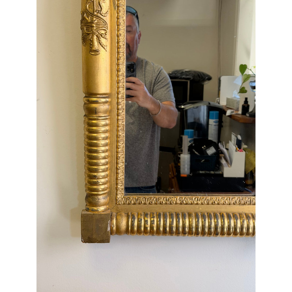 Close-up of an American Federal Giltwood Pier Mirror, Possibly Massachusetts or New York, circa 1815–1830, featuring a gold-leaf rectangular frame with fluted molding and carved floral corner details.