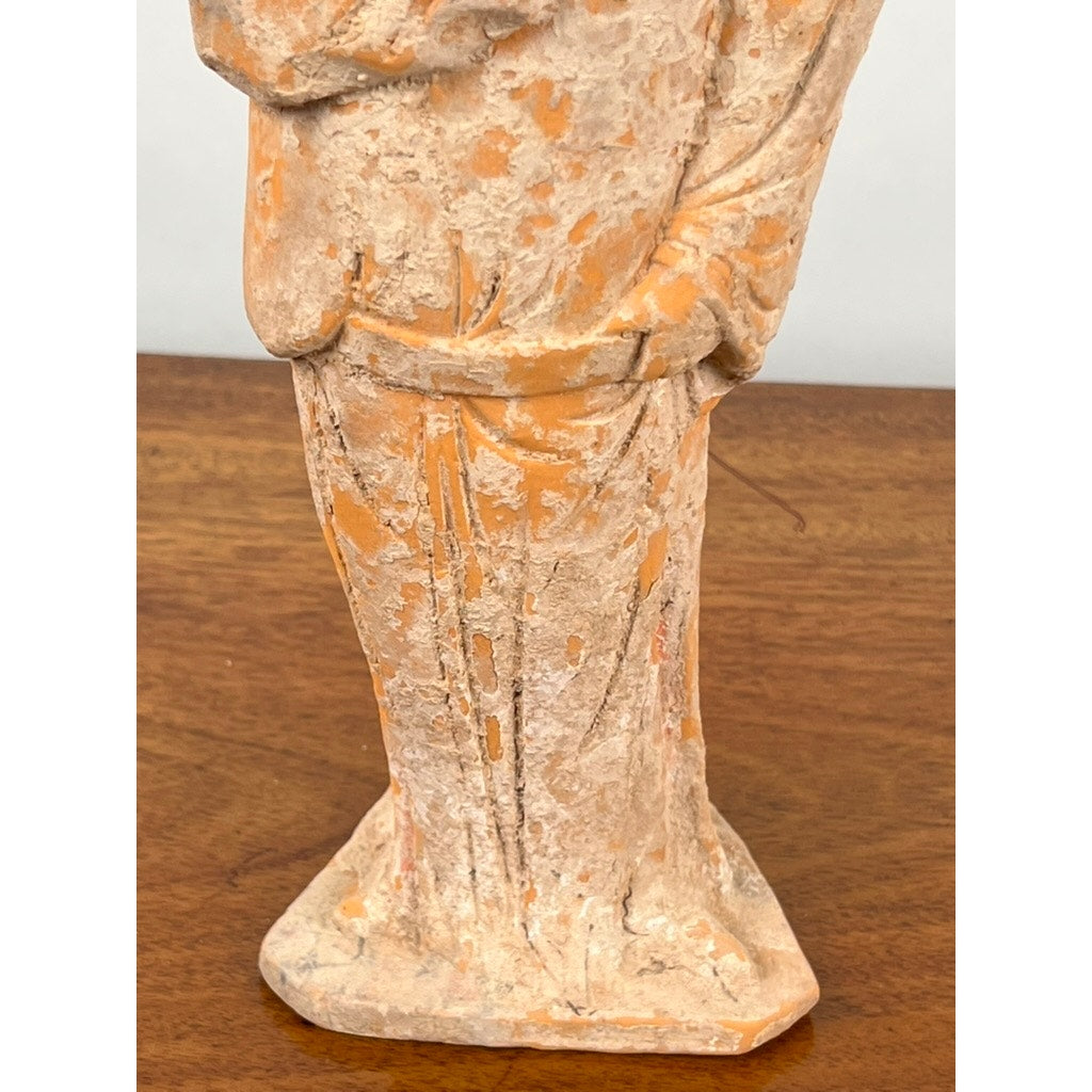 A close-up of an Antique Chinese Tang Dynasty (618-907 AD) terracotta figure of a standing court lady, showing textured orange-brown robes and square base, displayed on wood; includes COA. Brand: None/Unknown.