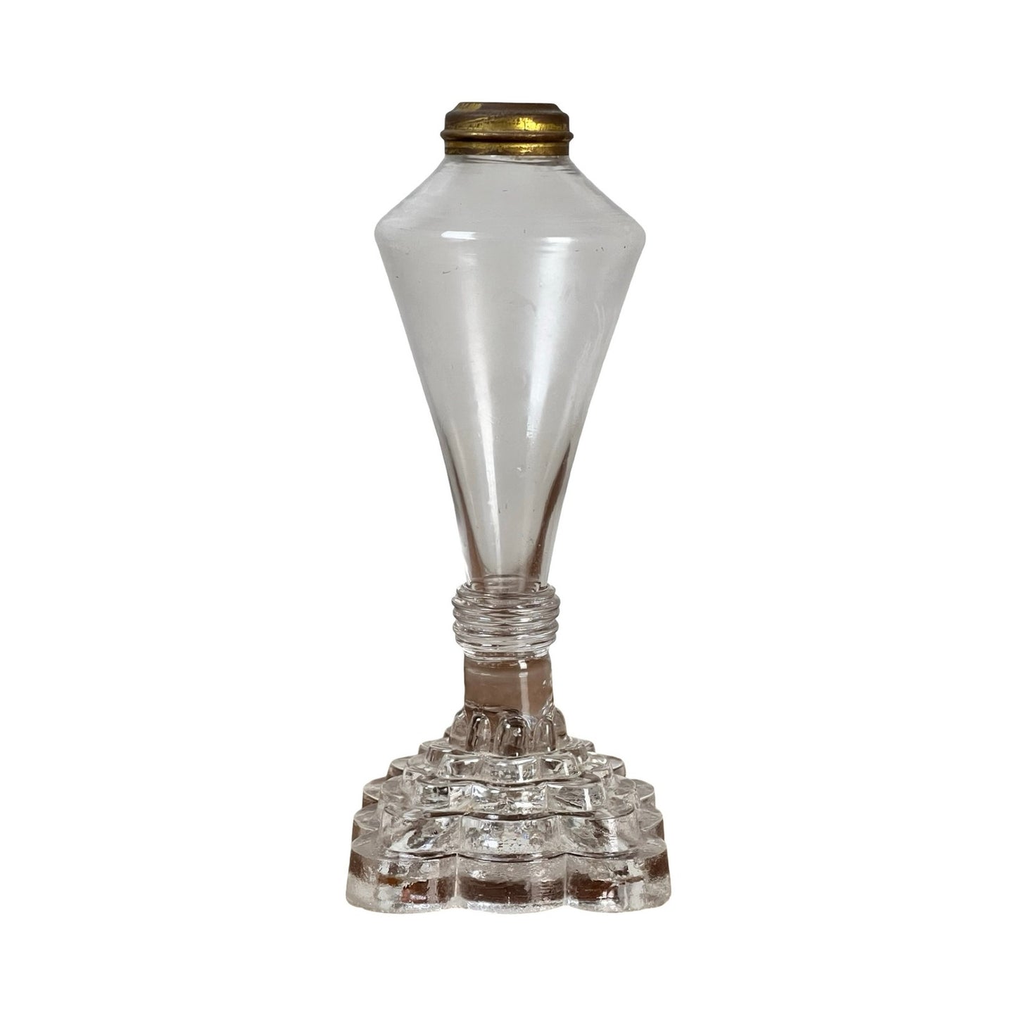 An attributed Boston & Sandwich pressed glass boudoir fluid lamp, circa 1850, crafted in clear glass with a brass top, featuring a geometric stepped base and a tall, tapered body—evoking the style of Victorian-era pressed glass lamps.