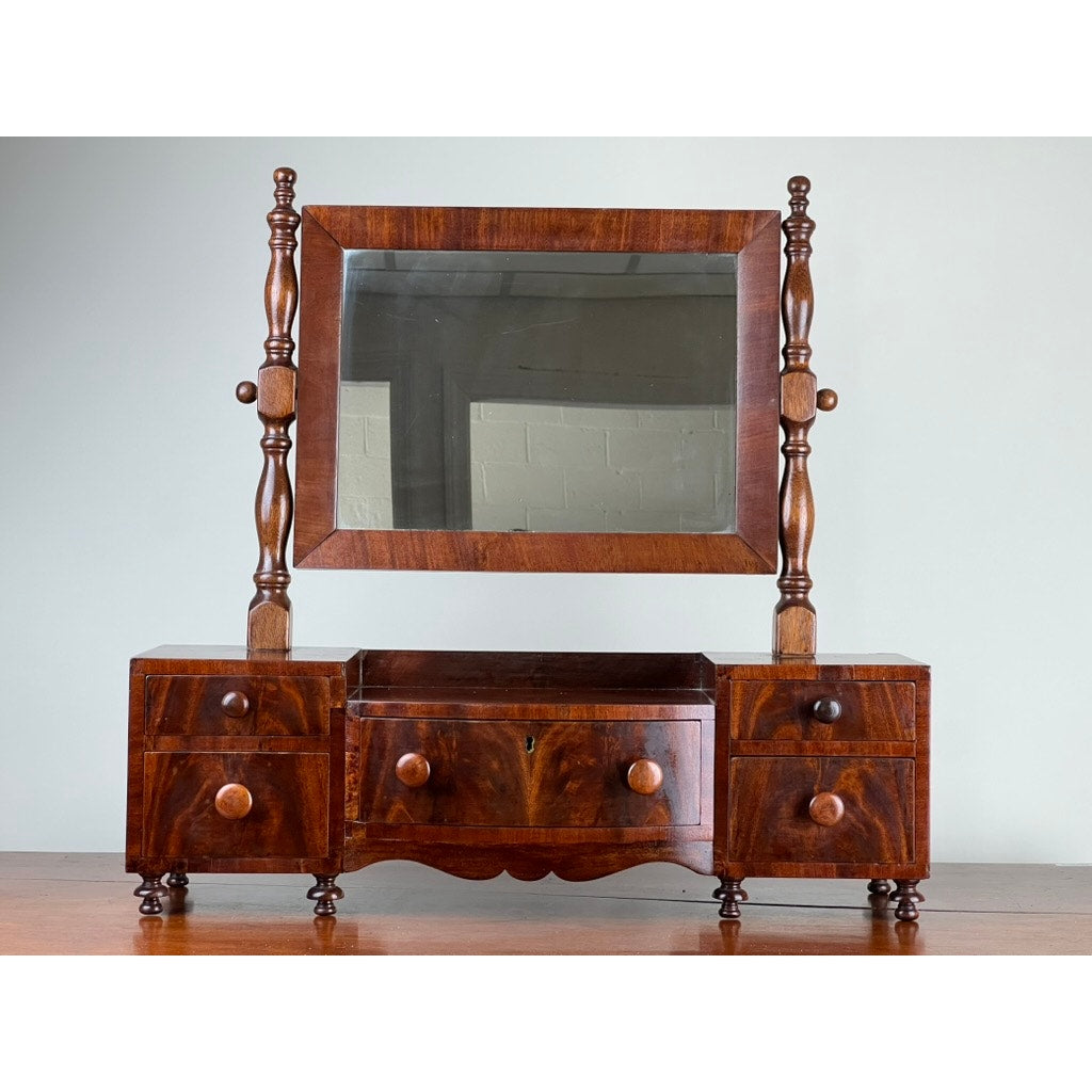 Early 19th century drop center shaving mirror with drawers and turned supports