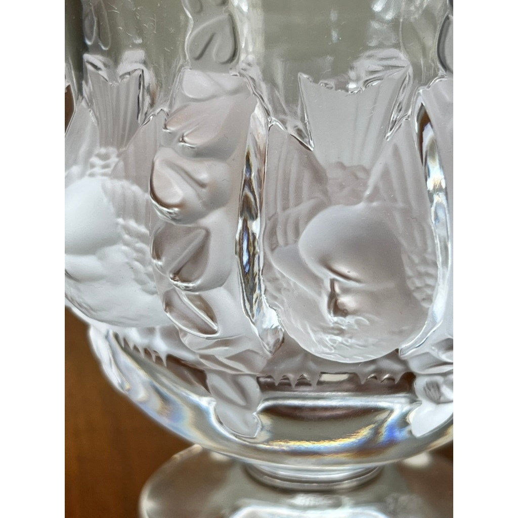 Close-up of a Vintage Lalique Dampierre Sparrow Footed Vase by Lalique, crafted from clear French crystal with intricate embossed birds and leaves, highlighting detailed, collectible glasswork.