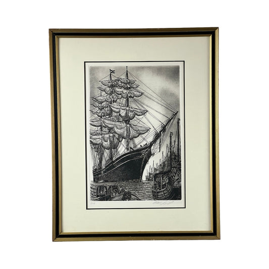Framed etching "The Whaling Ship Charles W Morgan" by Alan Jay Gaines, featuring the iconic vessel docked at a harbor with smaller boats; signed and elegantly matted.