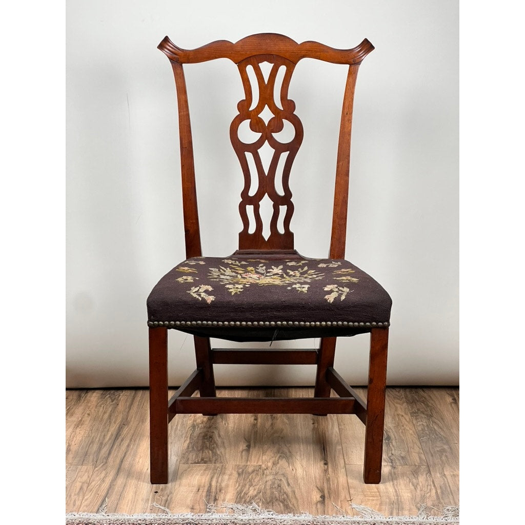 Antique Chippendale Side Chair with needlepoint seat, mid 19th century—features an ornate openwork backrest and embroidered floral fabric seat, shown on a wooden floor with a plain light background. Brand: Unknown.