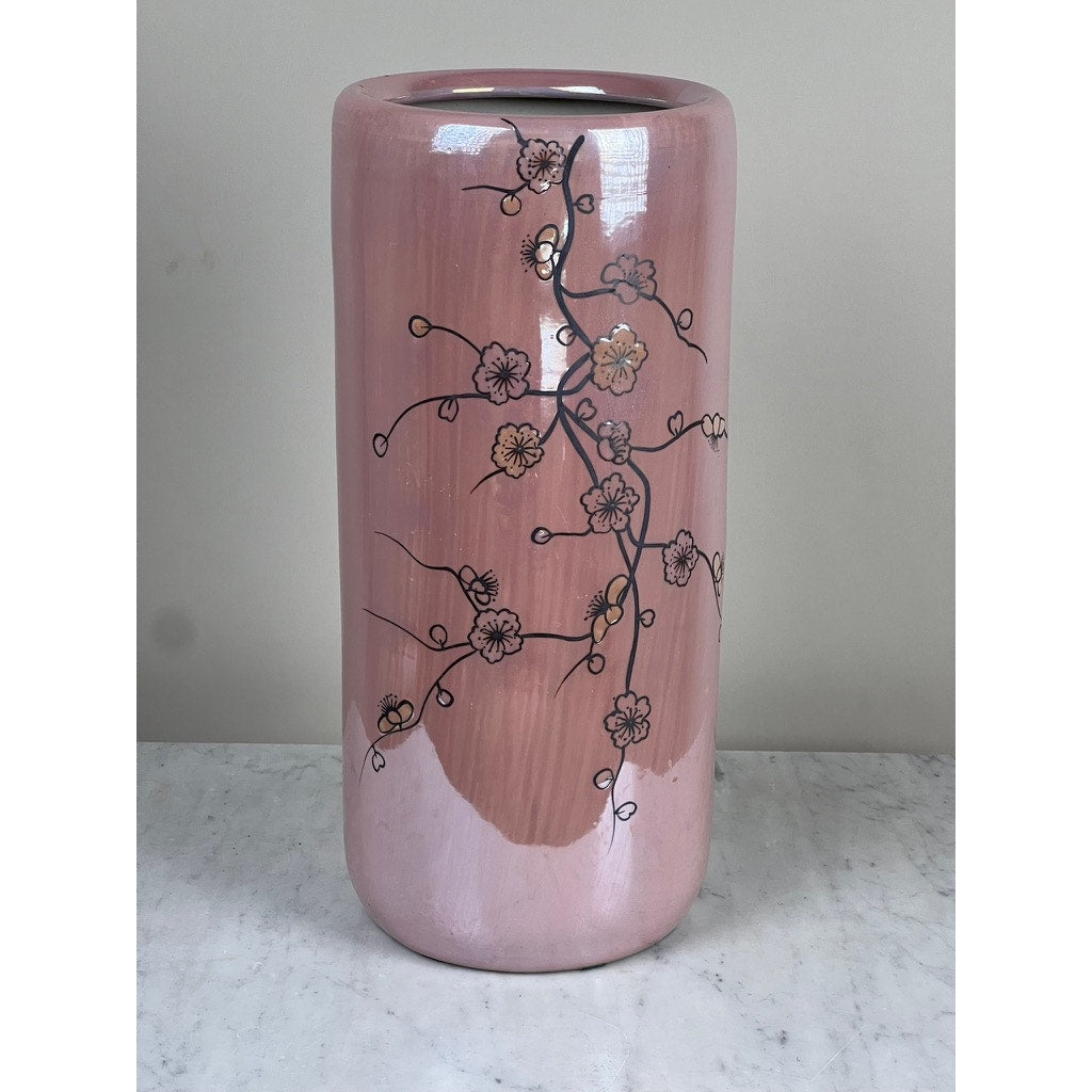 The Vintage Sakura Style Cherry Blossom Tall Vase features a glossy pink ceramic finish with delicate black branches and light pink cherry blossoms, displayed against a plain background on marble. Brand: None/Unknown.