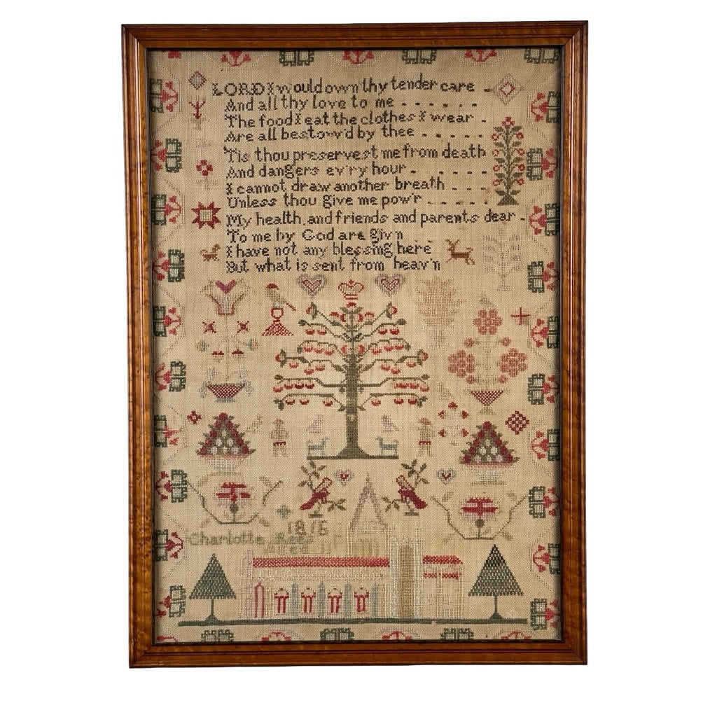 An exceptional English Regency schoolgirl needlework sampler by Charlotte Rees, age 11 and dated 1816, showcases a stitched religious verse alongside a tree, people, animals, houses, and an array of motifs in red, green, and brown thread on beige fabric. "Charlotte Rees" and the date "1816" are included near the lower left.