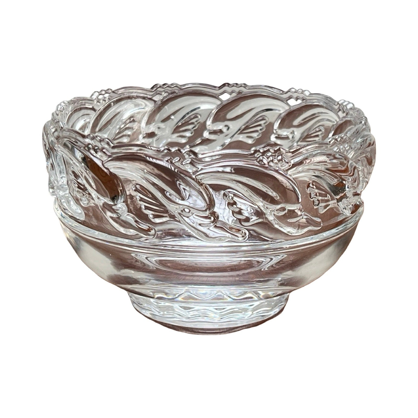 This Vintage Tiffany & Co. Mid-Century Modern Crystal Dolphin Pattern Footed Bowl features elegant embossed motifs and a smooth, rounded base, reflecting classic Tiffany & Co. craftsmanship.
