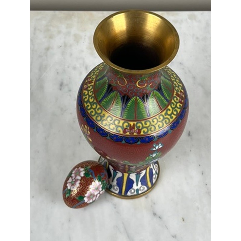 The Vintage Chinese Cloisonné Vase and Egg feature brass rims and intricate red, green, and blue floral patterns, showcasing vintage enamel artistry. The set includes a decorative vase and a matching floral-patterned egg ornament.