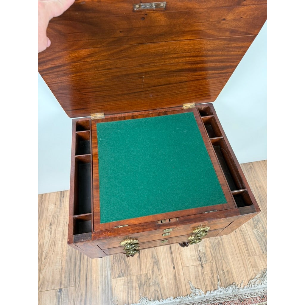 High-angle view of an American Classical Figured Mahogany Work Table, circa 1830–1845, featuring an open wooden top with a green felt-lined interior, divided compartments, and two brass-handled drawers.
