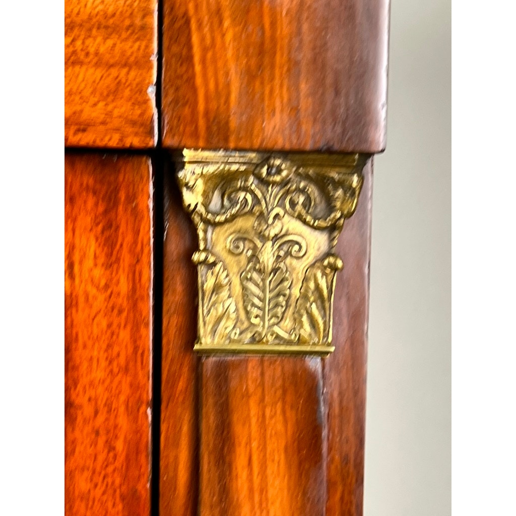 Close-up of an Antique French Empire Secrétaire Abattant with ormolu mounts, c. mid-19th century, showing ornate symmetrical corner design and polished reddish-brown mahogany veneer with visible wood grain patterns. Brand: Unknown.