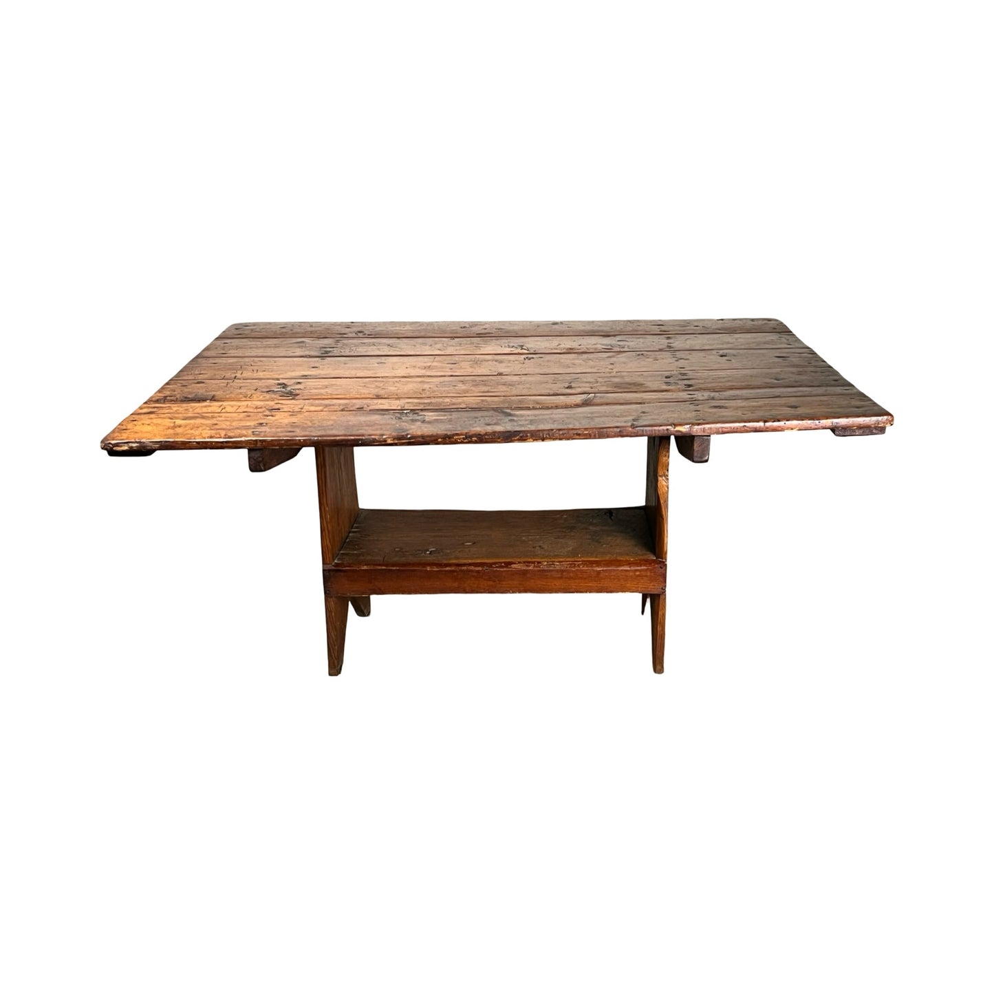 The Antique Country Pine Hutch Table with Six Plank Top c. 18th Century features a weathered rectangular surface, angled legs, and a lower shelf, inspired by classic country furniture and shown against a white background.