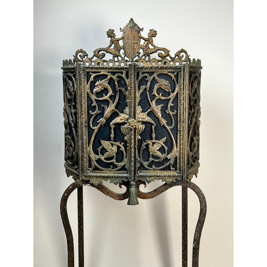 Antique Gothic Revival cast iron and brass phone stand, attributed to Oscar Bach or Bertram Segar, c. 1920 Greenwich Village, featuring ornate scrollwork and floral designs on slender legs, displayed against a plain white background.