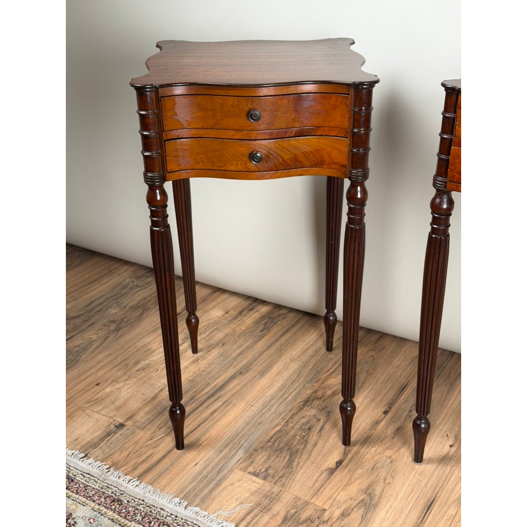 Pair of American Classical Revival Mahogany Two-Drawer Work Tables with scalloped tops, two drawers each, and slender fluted legs.