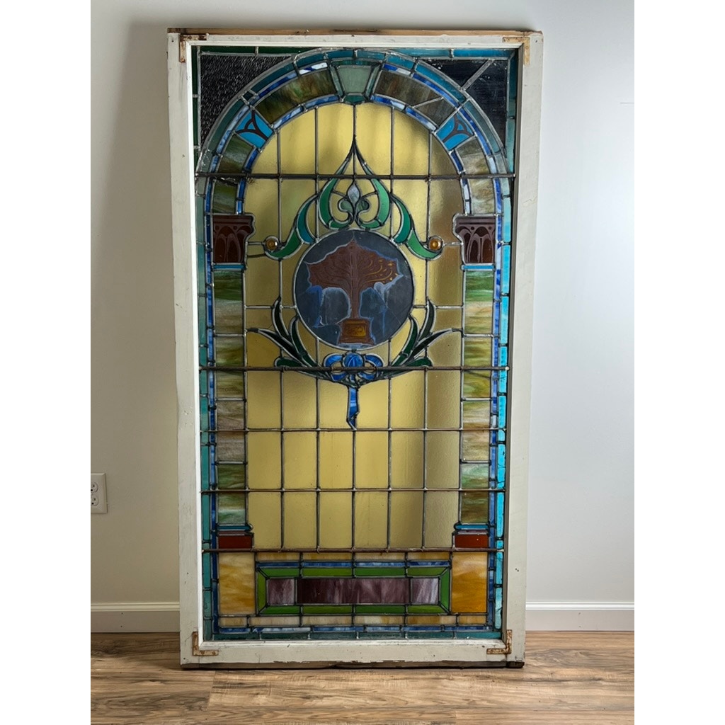 Early 20th century stained glass window in original wood frame