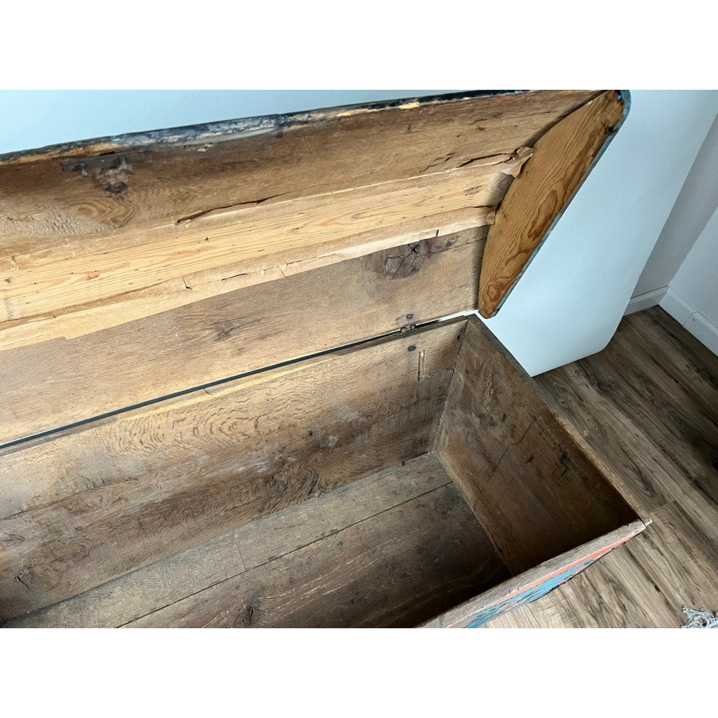 The Antique Swedish Oak Kista Dowry Chest c. 1841, with a hinged lid and visible aged wood inside, sits open and empty on a wooden floor near a white wall. Brand: Unknown.