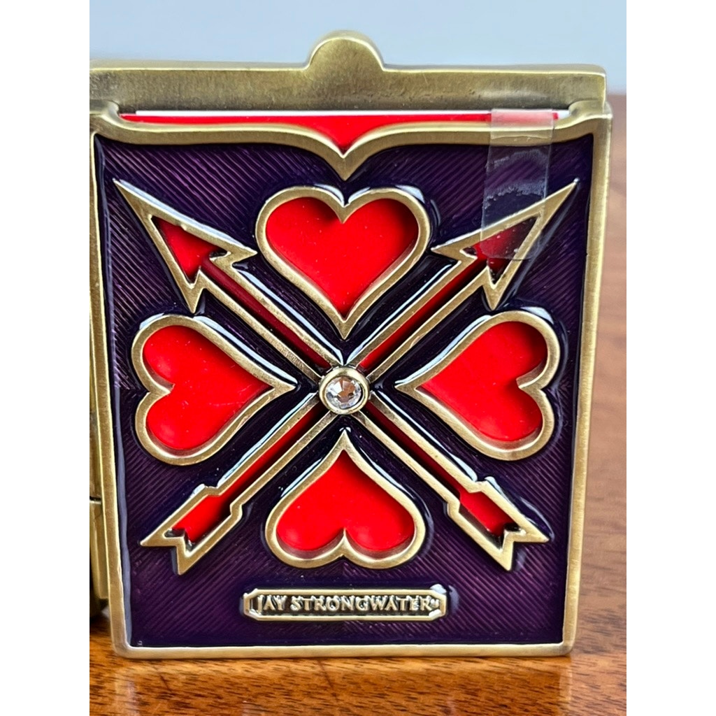 The Jay Strongwater Bejeweled Enamel Double Heart Picture Frame features double hearts and a gold border, with jeweled accents and the Jay Strongwater name at the bottom. New in box.